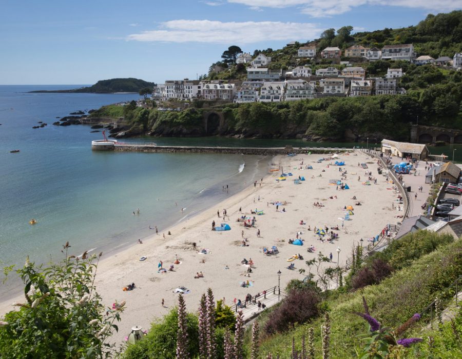 Fine weather attracted visitors back to the beach for the summer sunshine at Looe Cornwall on Saturday 11th July 2020
